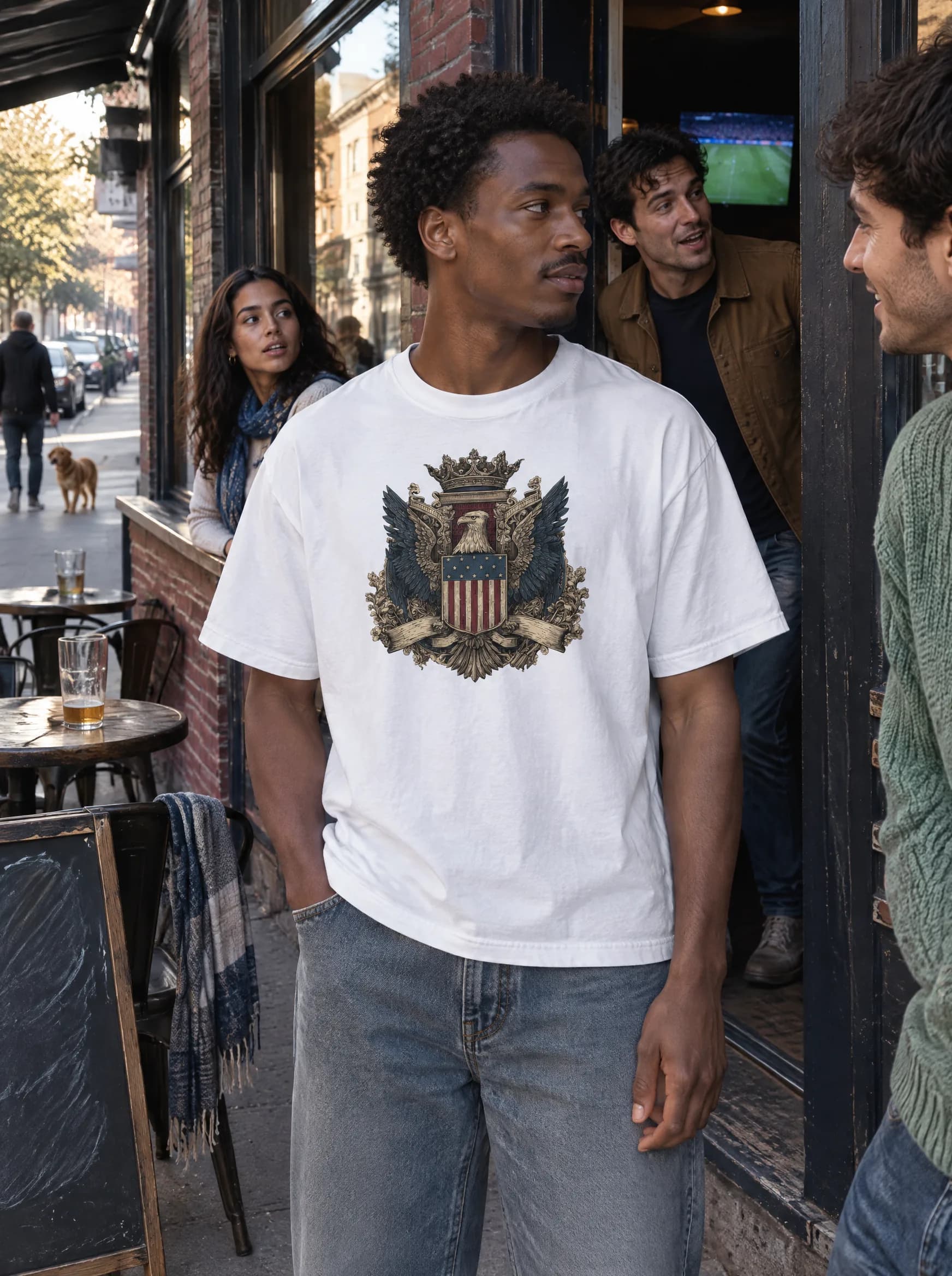Friends outside a neighborhood pub on match day, one in the House of America crest tee